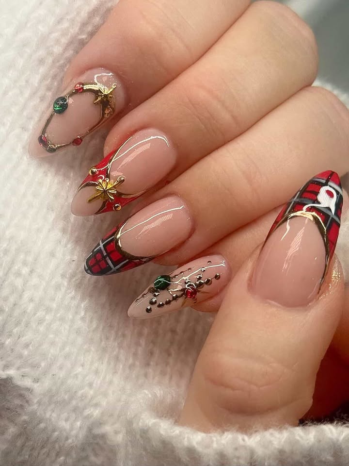 Holiday nails with tartan plaid tips, gold bows, and gem accents