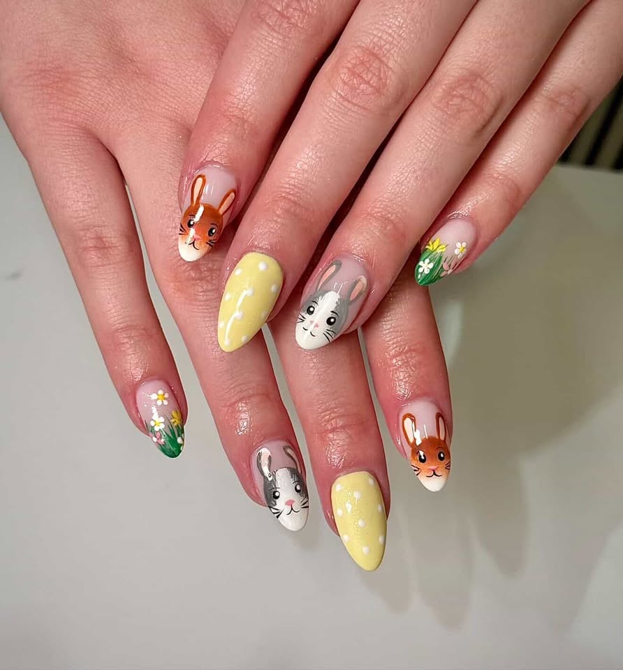 Pastel nails with painted bunnies, daisies, and polka dots