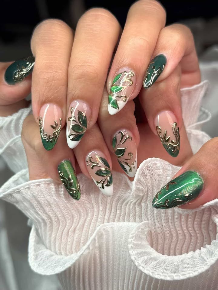 Emerald green nails with gold chrome floral detail
