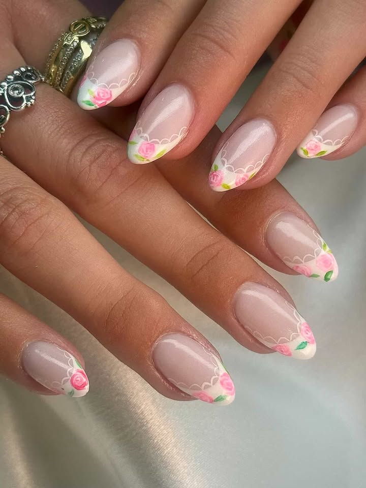 Nude nails with painted pink roses and white lace French tips