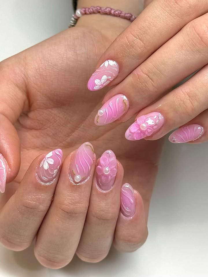 Pink marbled nails with 3D flowers and pearl accents