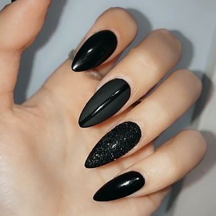Glossy black nails with glitter accent
