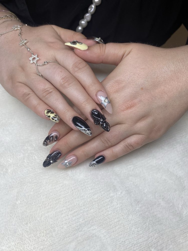 Gothic nails with 3D bow charms and butterfly details