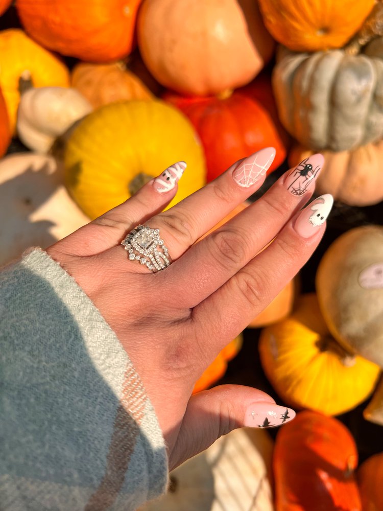 Halloween themed nail art with ghosts and spider webs