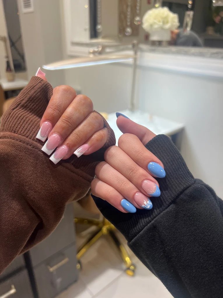 Light blue almond nails with white shell accent and French tip variations